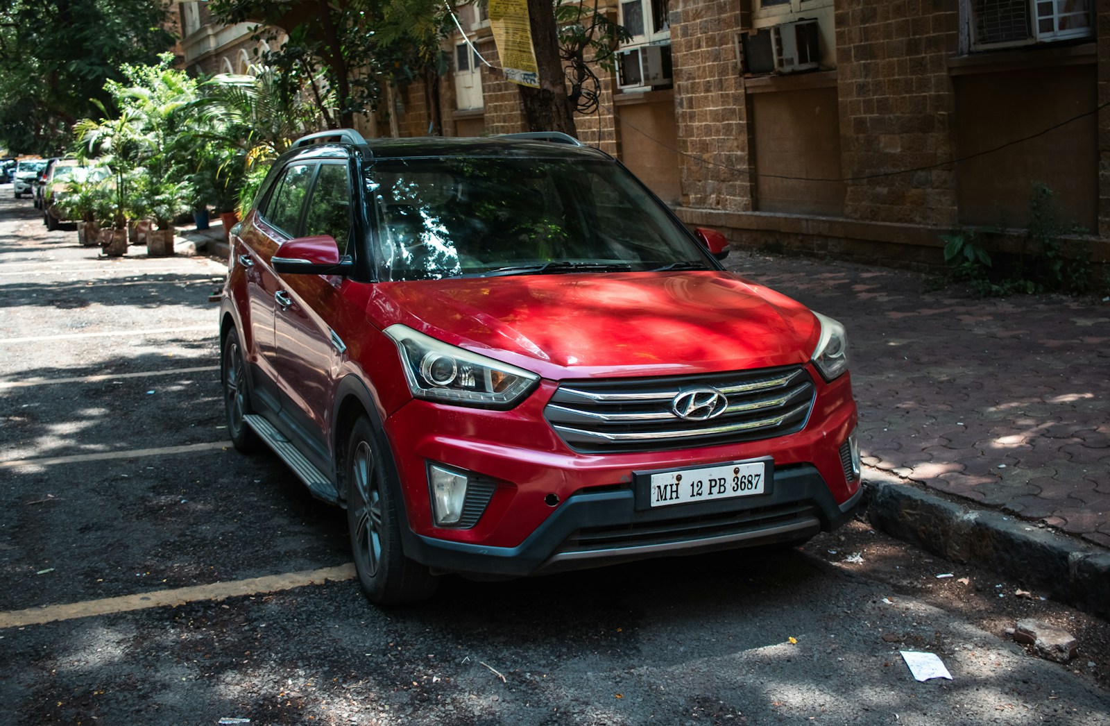 A red Hyundai Creta parked on a street